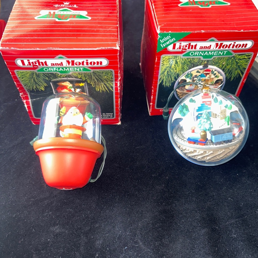 2 vintage Hallmark light and motion ornament in Ex working condition.